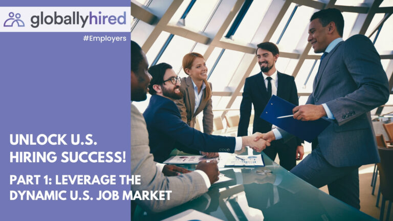 A diverse group of business professionals around a table with two people shaking hands.