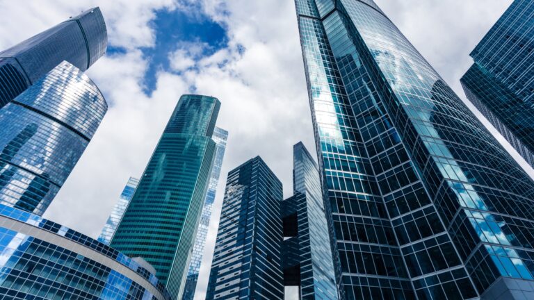 Tall business buildings and partly cloudy skies